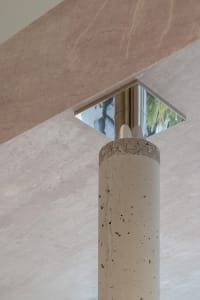 Concrete column supported by a marble base
