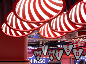 Retail interior featuring red and white striped lighting fixtures.
