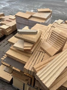 A stack of various ceramic construction materials.