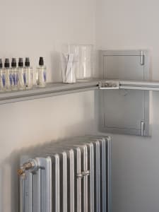 Industrial-style commercial space with metallic radiator and shelving unit.