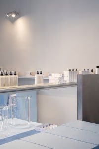 A laboratory scene featuring minimalist design with glass containers and equipment.