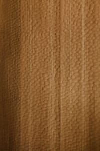 Close-up image of a textured wooden wall surface