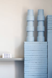 A minimalist shelf made of concrete blocks.