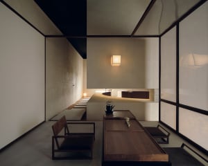 A modern tea room featuring concrete, paper, and wood materials.