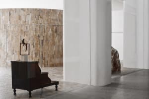 A modern interior featuring wooden furniture against a textured wall.