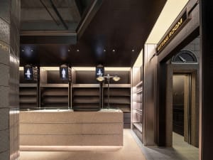 Modern retail shop with concrete exterior and illuminated signage.