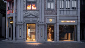 A storefront with brick walls and glass windows in a city center retail area.