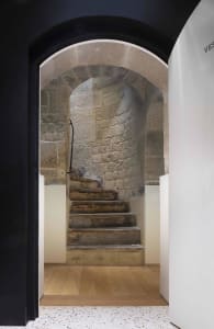 A rustic stone staircase within a building.