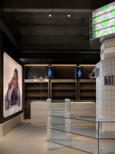 Modern retail store interior with concrete and glass elements.