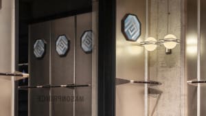 Modern retail storefront with metallic geometric elements.