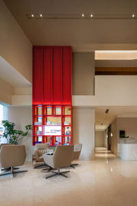 A minimalist commercial interior featuring a prominent red-lit shelf.