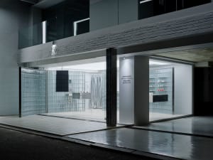 A modern storefront with a glass facade and white interior.