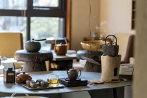 A detailed view of a ceramic tea room setup with various teapots and cups.