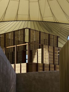 Modern interior design featuring a wooden structure and a tent-like roof.