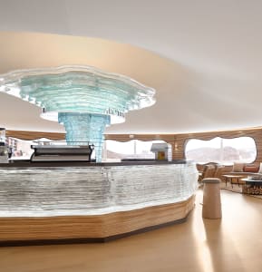 Modern coffee bar featuring a unique glass counter design