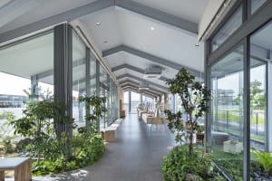 An image of a modern commercial interior featuring glass walls and concrete flooring.