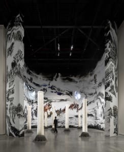 A modern installation art piece featuring mixed media materials and a dramatic, immersive space.