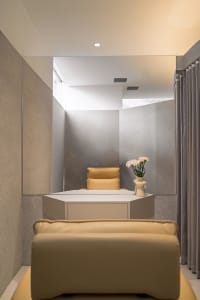 A minimalist office space featuring concrete and leather materials.
