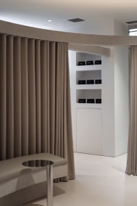 A minimalist spa interior with white stone curtains and modern design elements.