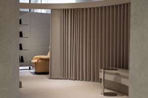 A modern interior design featuring space-divider curtains made of fabric.