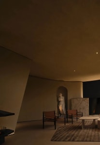 Modern minimalist living room with concrete walls and furniture.
