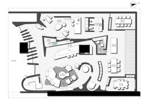 A modern office space with various functional zones such as a meeting room, lounge area, and conference room.