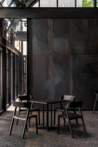 A modern industrial café with metal table and chairs.