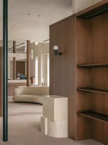 A modern living room featuring wooden shelving units and contemporary furniture.
