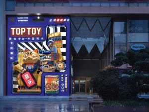 A brightly lit toy store storefront with a large robot cat display in the window.