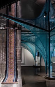 An industrial design installation featuring a teal textile installation
