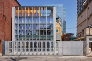 A modern office building with large glass windows and a sleek design.