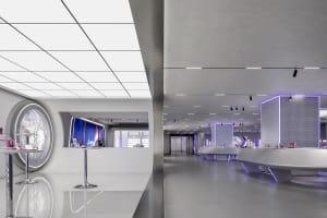 A modern retail space featuring concrete walls, glass displays, and metal fixtures.