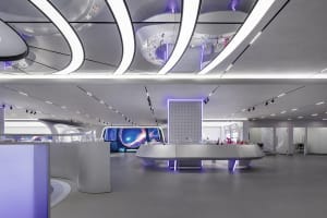 A modern scientific exhibit space featuring metallic and glass materials with lights.