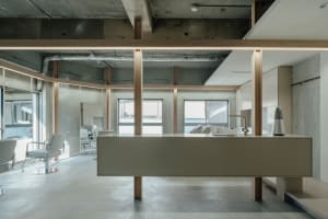 Modern Art-Deco coffee shop interior featuring concrete, steel, and minimalist design elements.