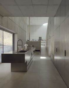 A contemporary kitchen with minimalist design and concrete finishes