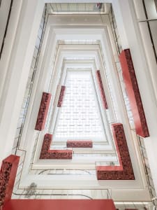 An interior office space with modern architectural elements, including glass and metal.