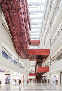 A shopping center interior with modern design elements including glass and metal.