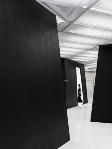 A minimalist black interior space with clean lines and a sleek design.