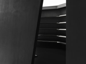 Modern black staircase with metallic elements.