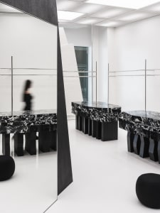A modern retail storefront featuring black marble surfaces and minimalist design.