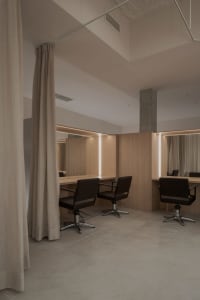 Modern minimalist salon featuring wood and glass materials.
