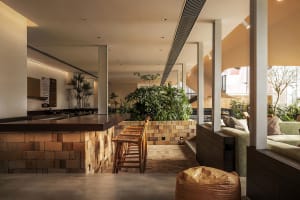 Interior design of a coffee shop featuring brick and concrete materials.