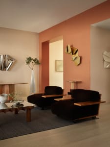 Modern living room featuring two dark brown velvet armchairs with wooden armrests and legs, placed on a dark gray rug over li
