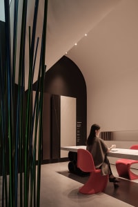 A modern restaurant with metallic decor and marble countertops.