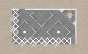 A modern garden with a concrete pavement featuring a geometric pattern, including a round table and chairs set.