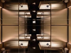 Modern hotel room with metallic steel furniture and beds.