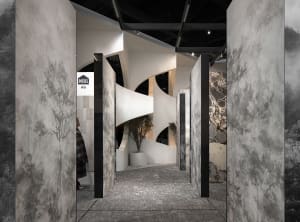 Modern interior exhibition space with concrete and marble materials.