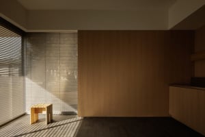 A minimalist interior design featuring wooden walls and tiled flooring.
