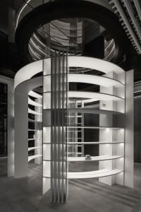 A minimalist interior design featuring a white lighting structure.