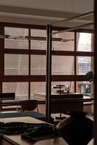 Modern coffee shop featuring brick walls and large glass windows.